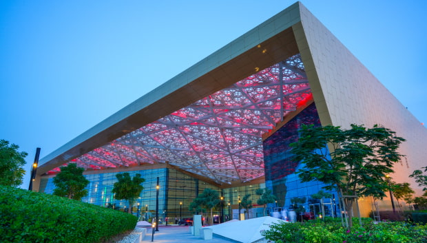 The exterior of Exhibition World Bahrain, enhancing its architectural features in a dramatic display