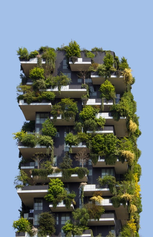 A tall building adorned with plants on its balconies, showcasing a vibrant urban environment .